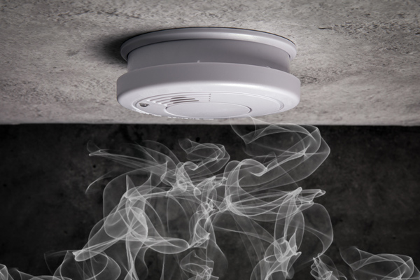  fire alarm on ceiling with smoke rising